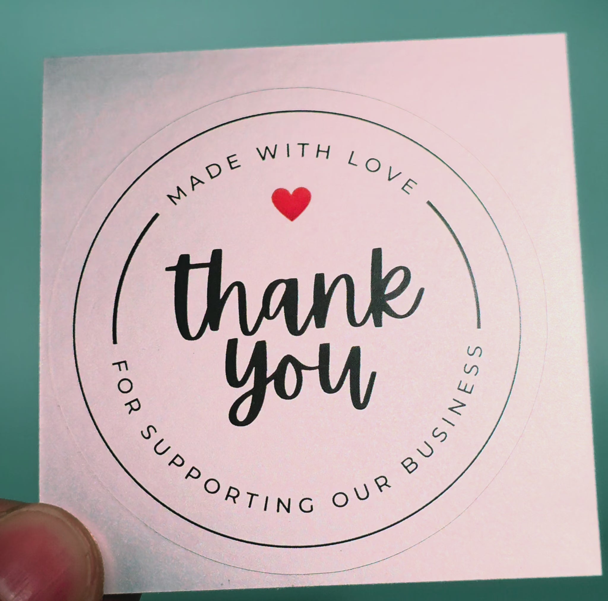 Pure Pack silver vinyl thank you stickers catching the light to show the metallic shine, round small business packaging label