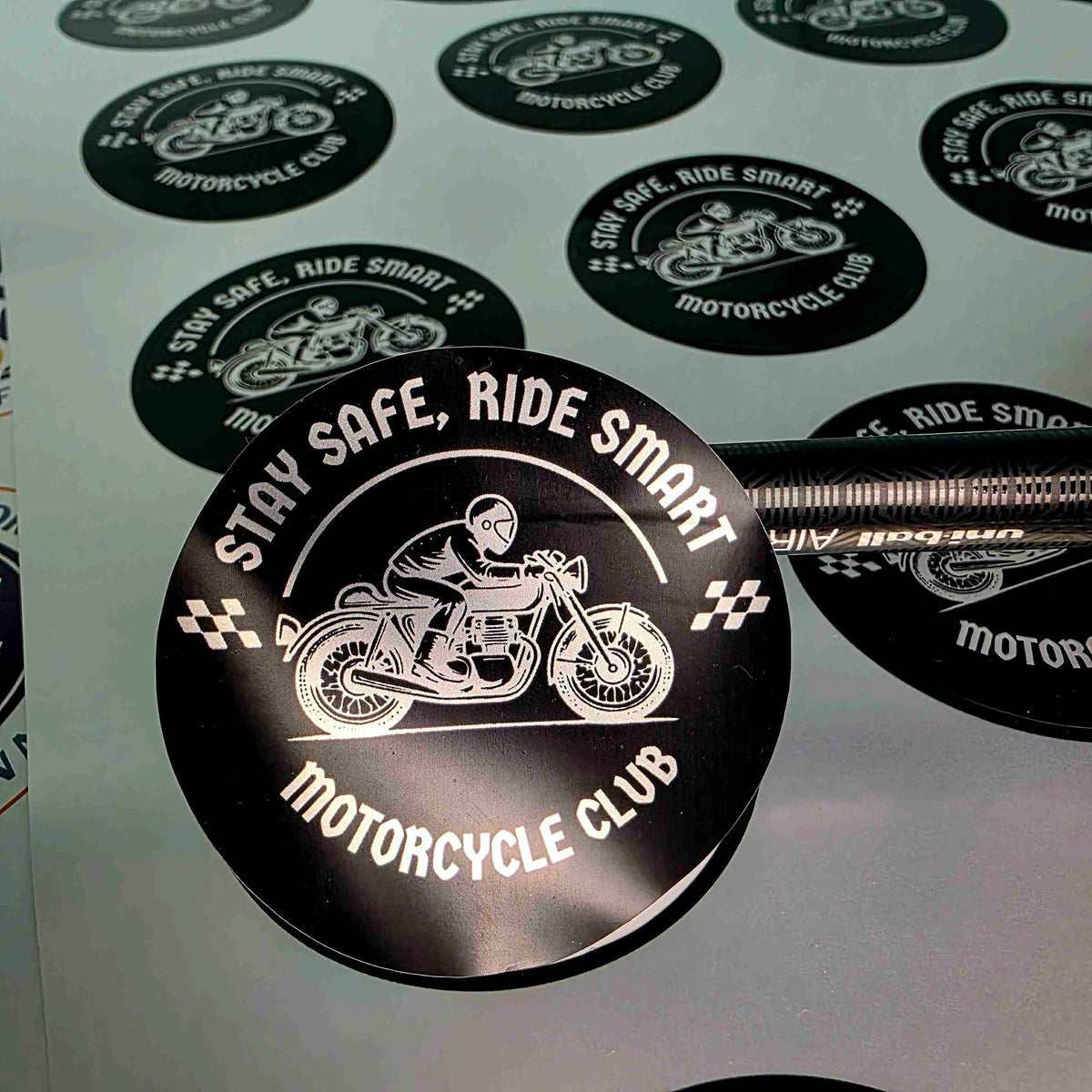 Custom round silver vinyl stickers by Pure Pack, black motorcycle club design with a shiny metallic silver finish