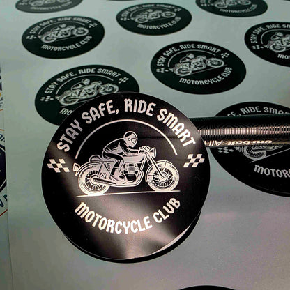 Custom round silver vinyl stickers by Pure Pack, black motorcycle club design with a shiny metallic silver finish