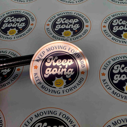 Pure Pack silver vinyl stickers printed in full colour, round Keep Going logo design with a reflective silver shine